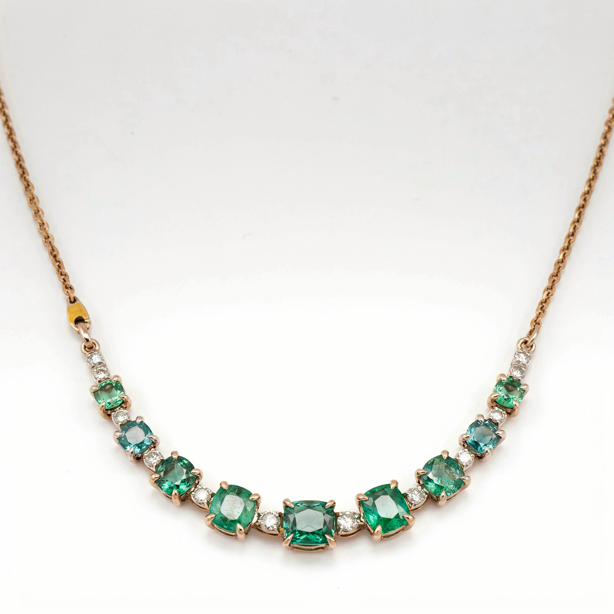 Fixed synthetic rose-gold necklace with nine green stones and white stone separators
